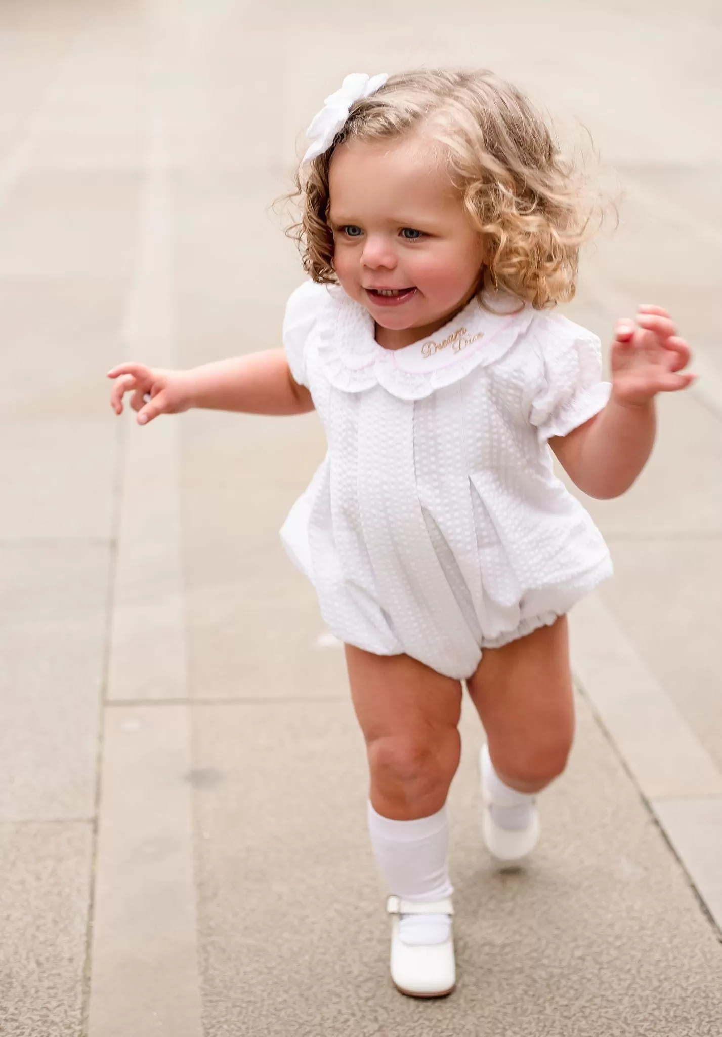 Girls Seersucker Short Sleeve Romper Trimmed With Pink