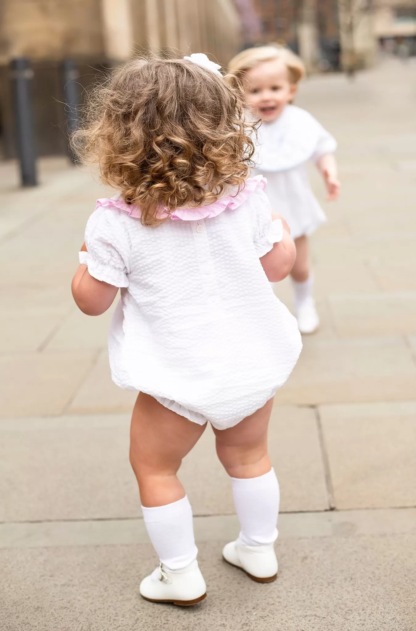 Girls Seersucker Short Sleeve Romper Trimmed With Pink