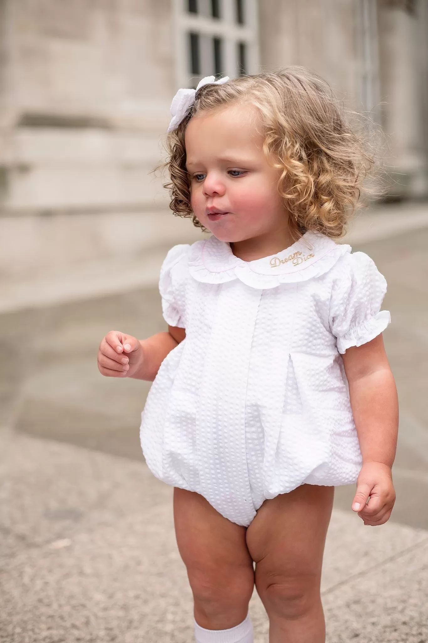 Girls Seersucker Short Sleeve Romper Trimmed With Pink